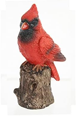 A coleção de ponte Little Cardinal empoleirou -se em uma estatueta de ramo